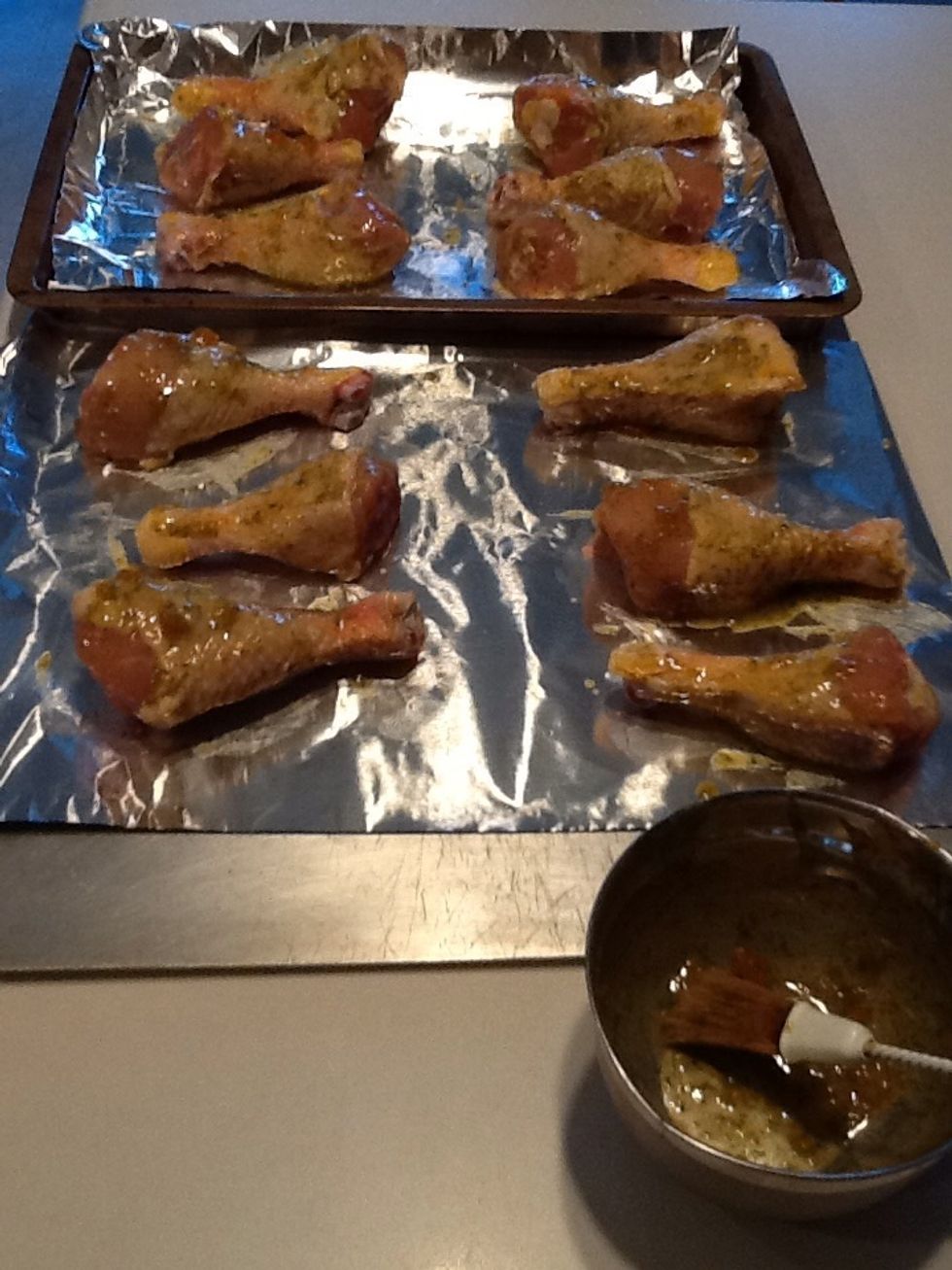 Put foil on baking sheets and lay out drumsticks. Coat with sauce. Flip drumsticks and coat other side. Put lots of sauce on this side, even going under the skin if you can.