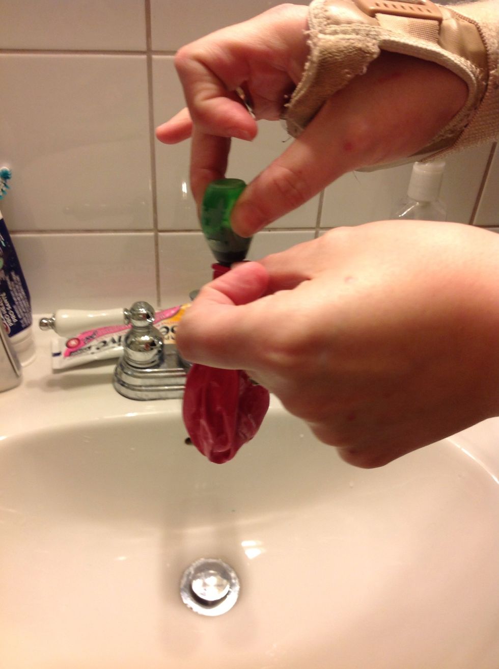 Put food colouring or some type or dye in the empty balloon