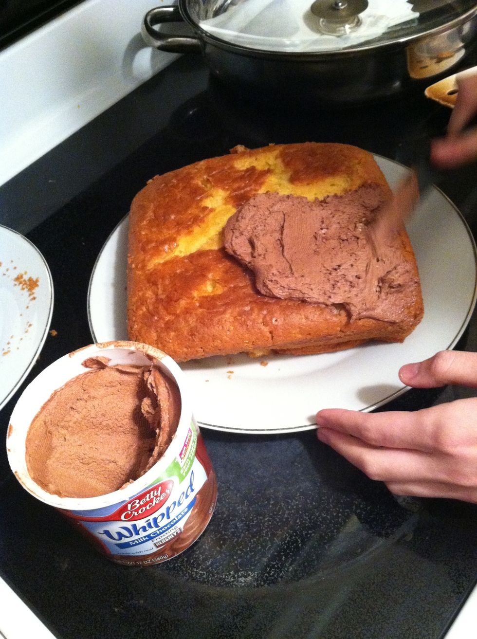 Put frosting on the cake