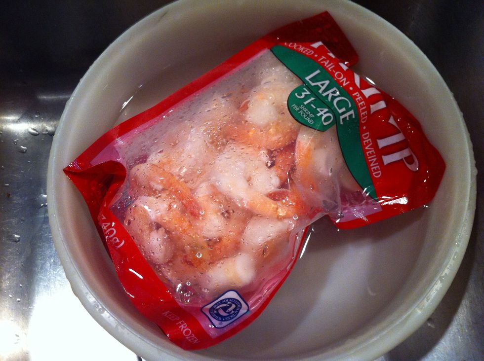 Put frozen shrimp, without opening the package, into cold water. Also, pour chicken broth into pan. Put on medium high, until it starts boiling. Soon as its boiling, add pasta. Cook for 10-12 min.