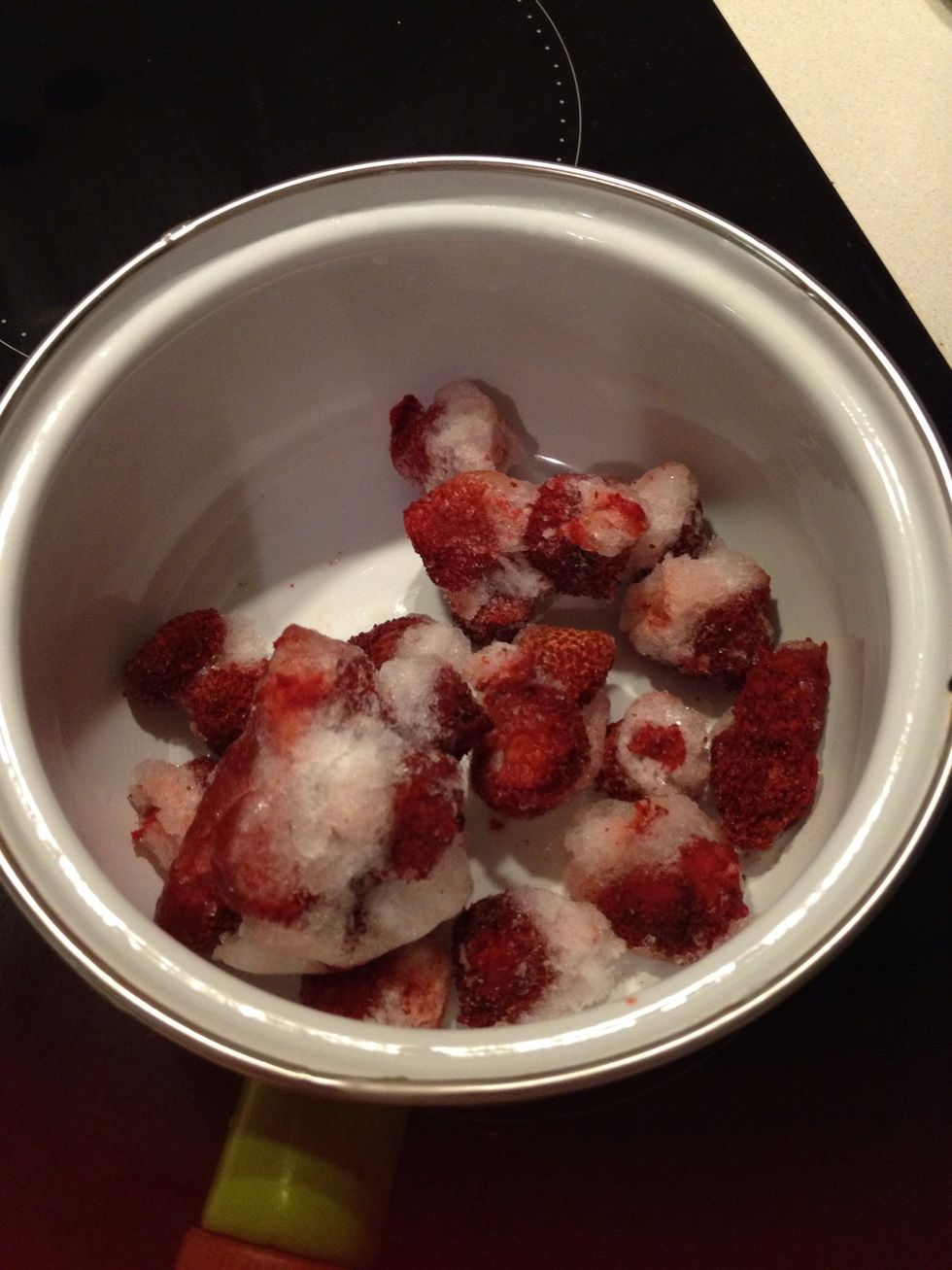 Put frozen strawberries or any fruit of your choice in a pot.