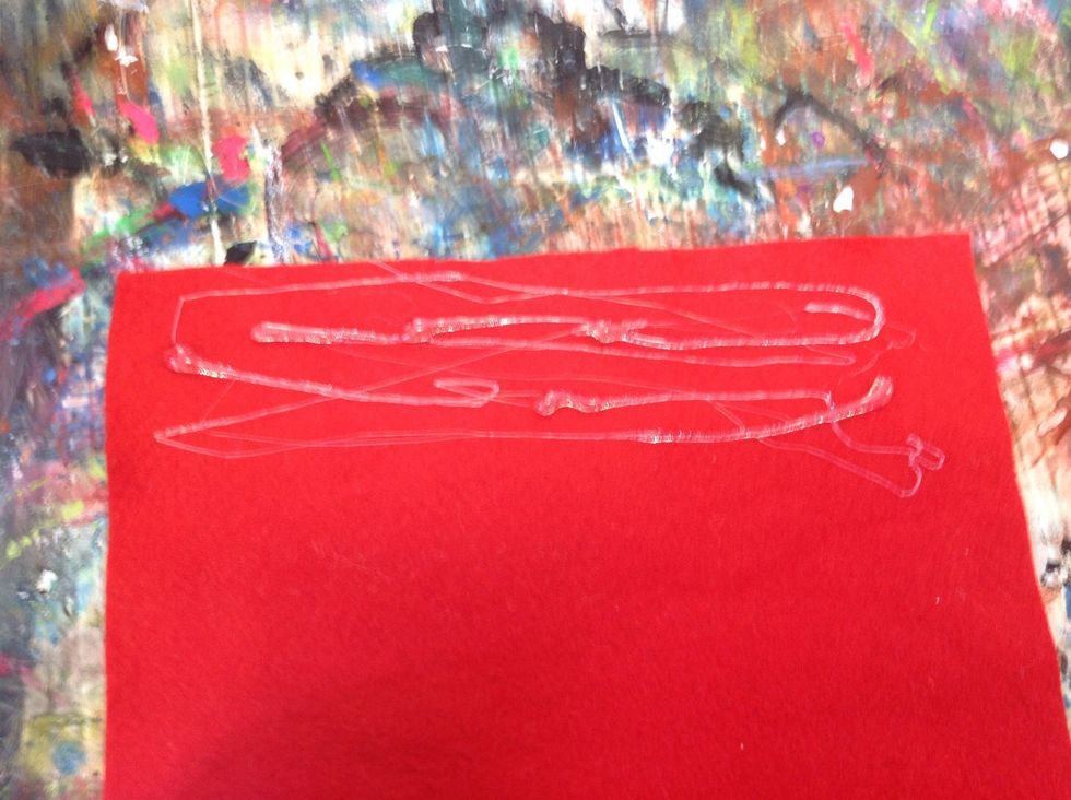 Put glue at the top of the red stocking. Then stick the white felt onto the stocking