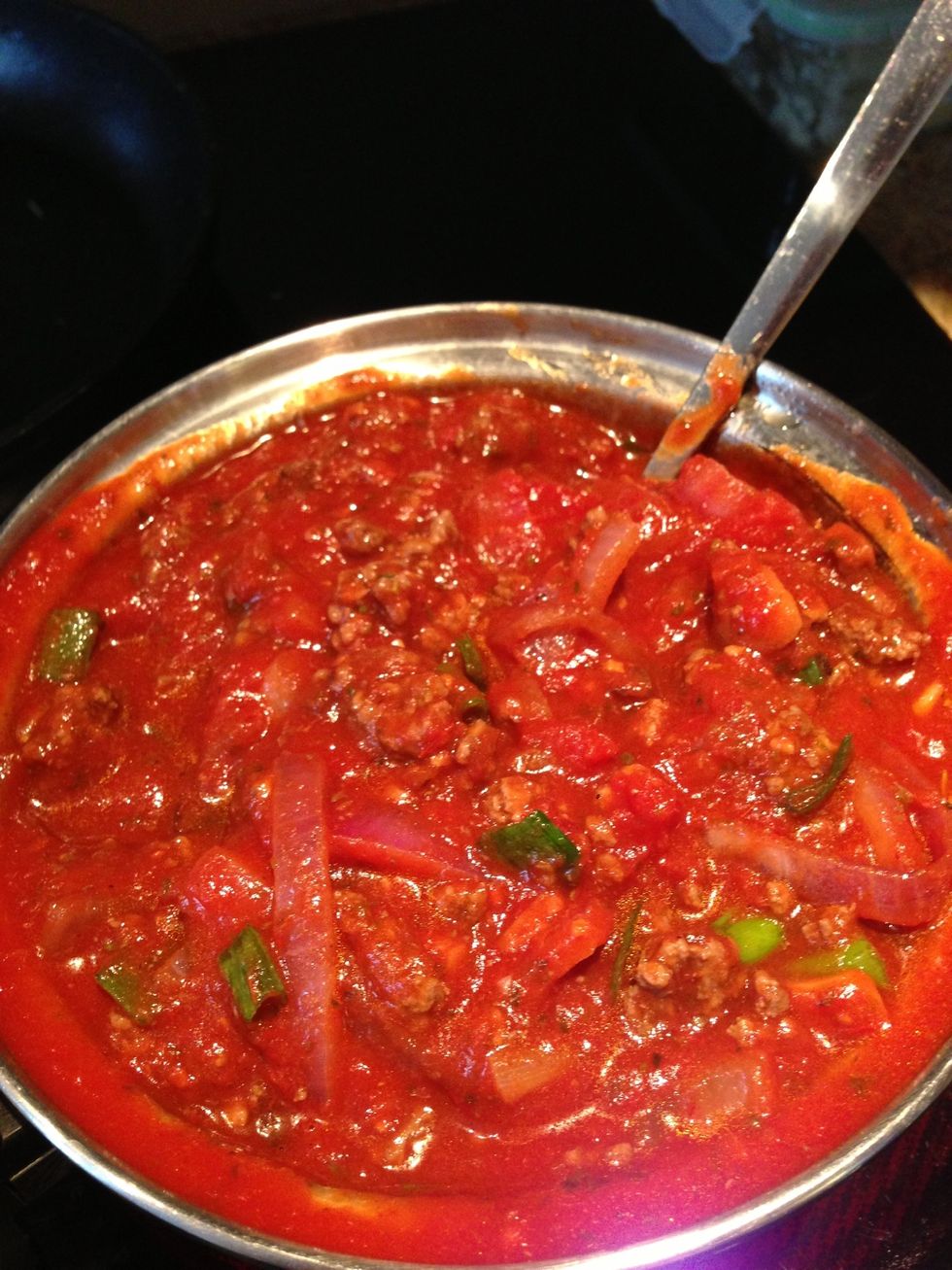 Put ground beef into sauce. Add green onion and mushrooms. Bring to a simmer