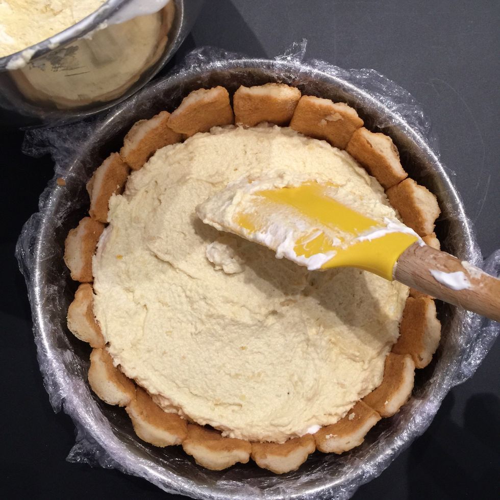 Put half of the cream. Top with one layer of biscuits dipped in the orange juice