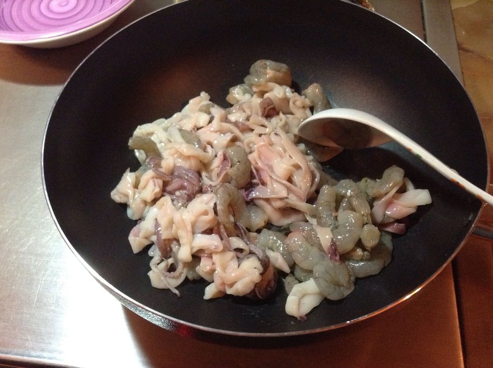 Put half oil on the wok when it is hot add the shrimps and calamari