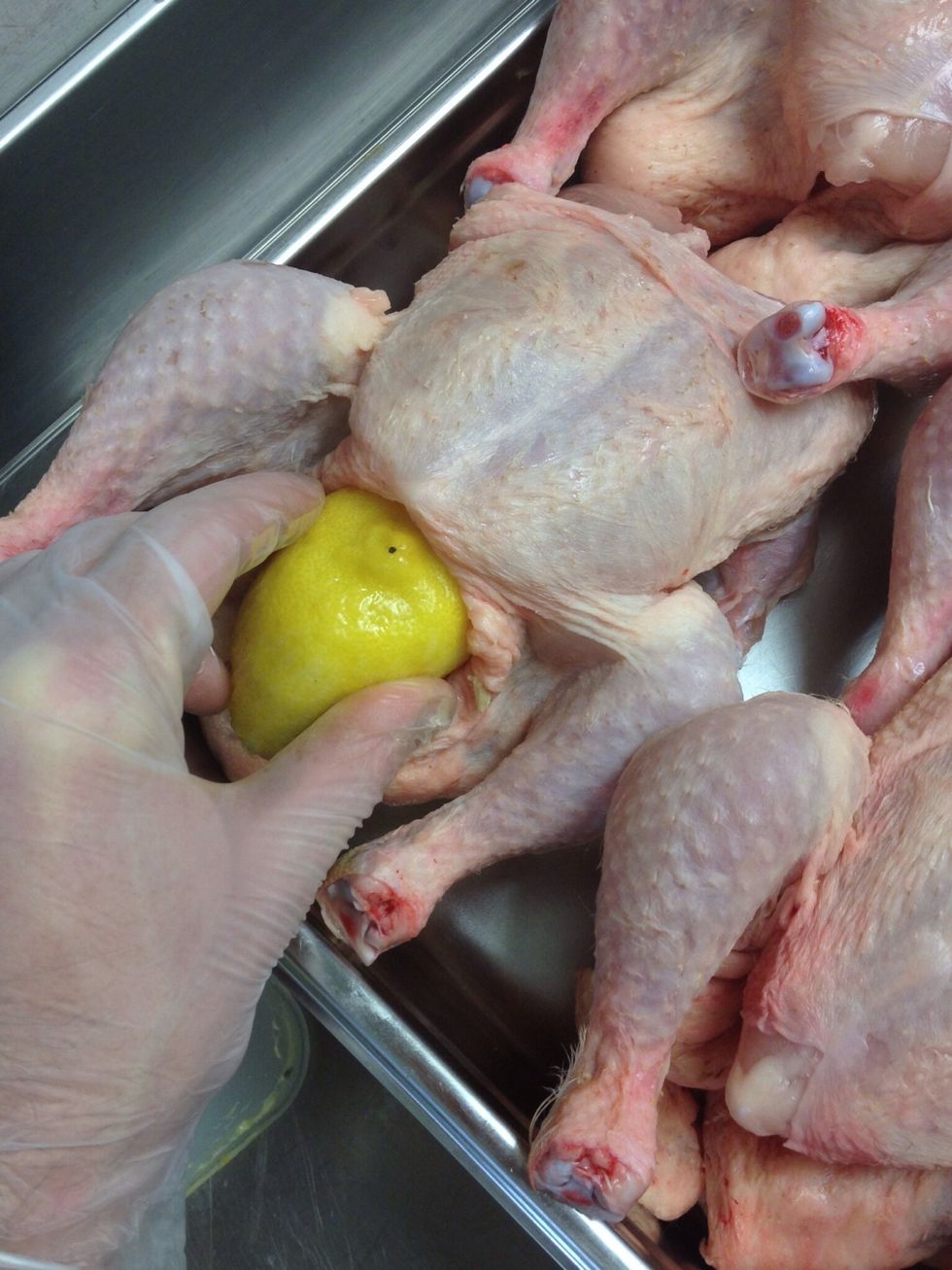 Put half the lemon in the chicken