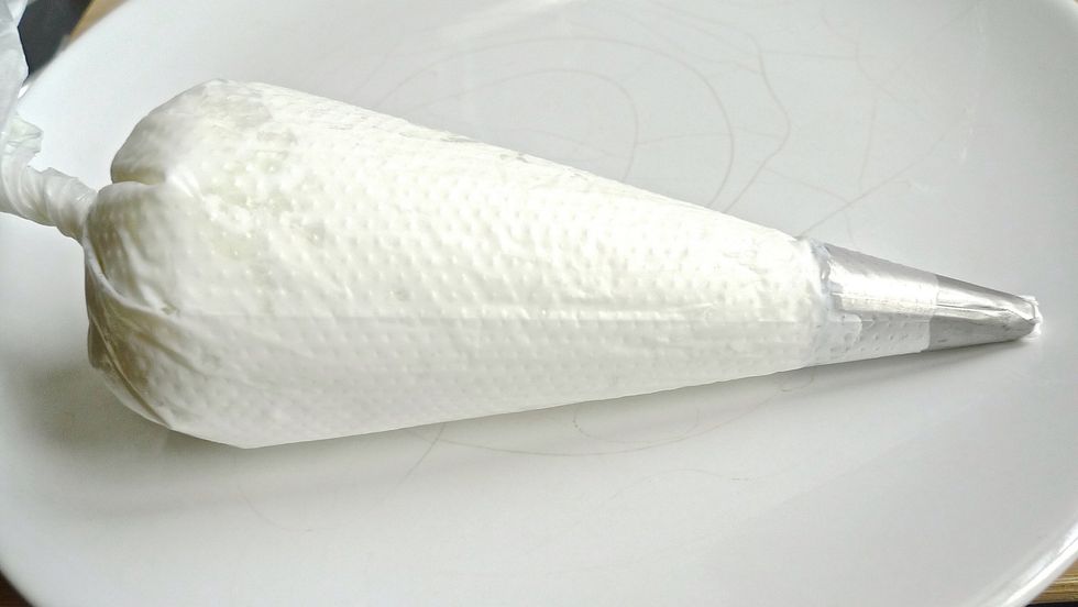 Put half the whipped topping frosting into a piping bag.
