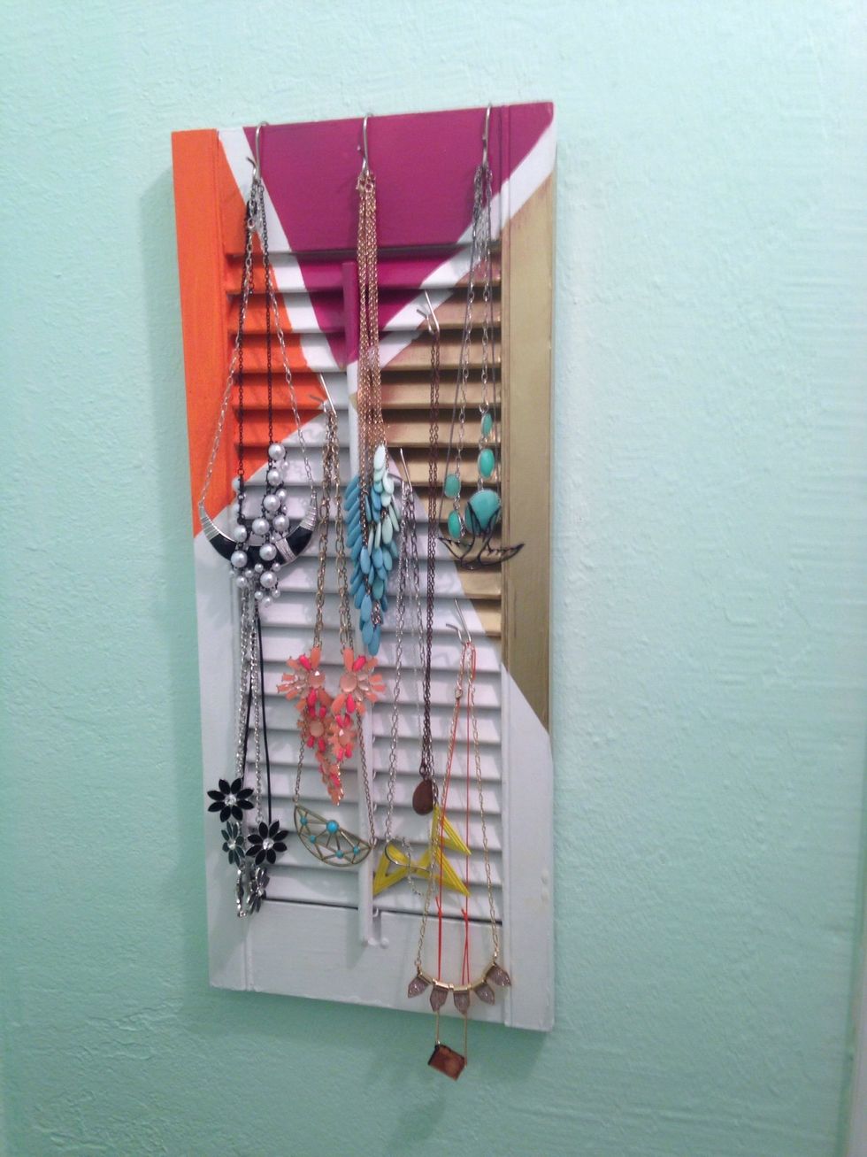 Put hooks on the shutter, add necklaces, and your done!