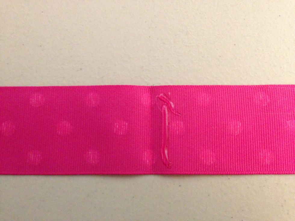 Put hot glue on one side of the crease