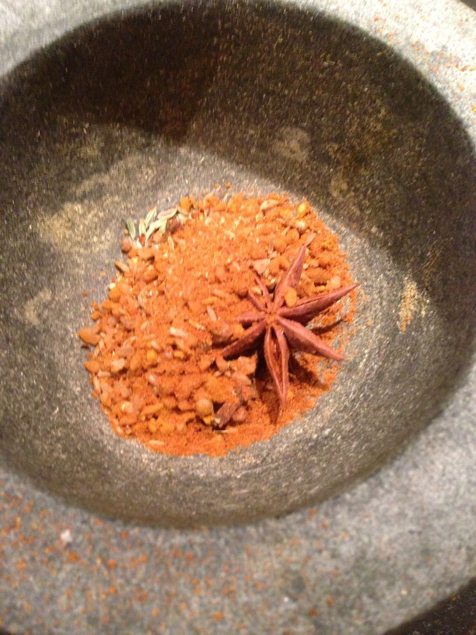 Put hot spices into mortar and pestle and grind