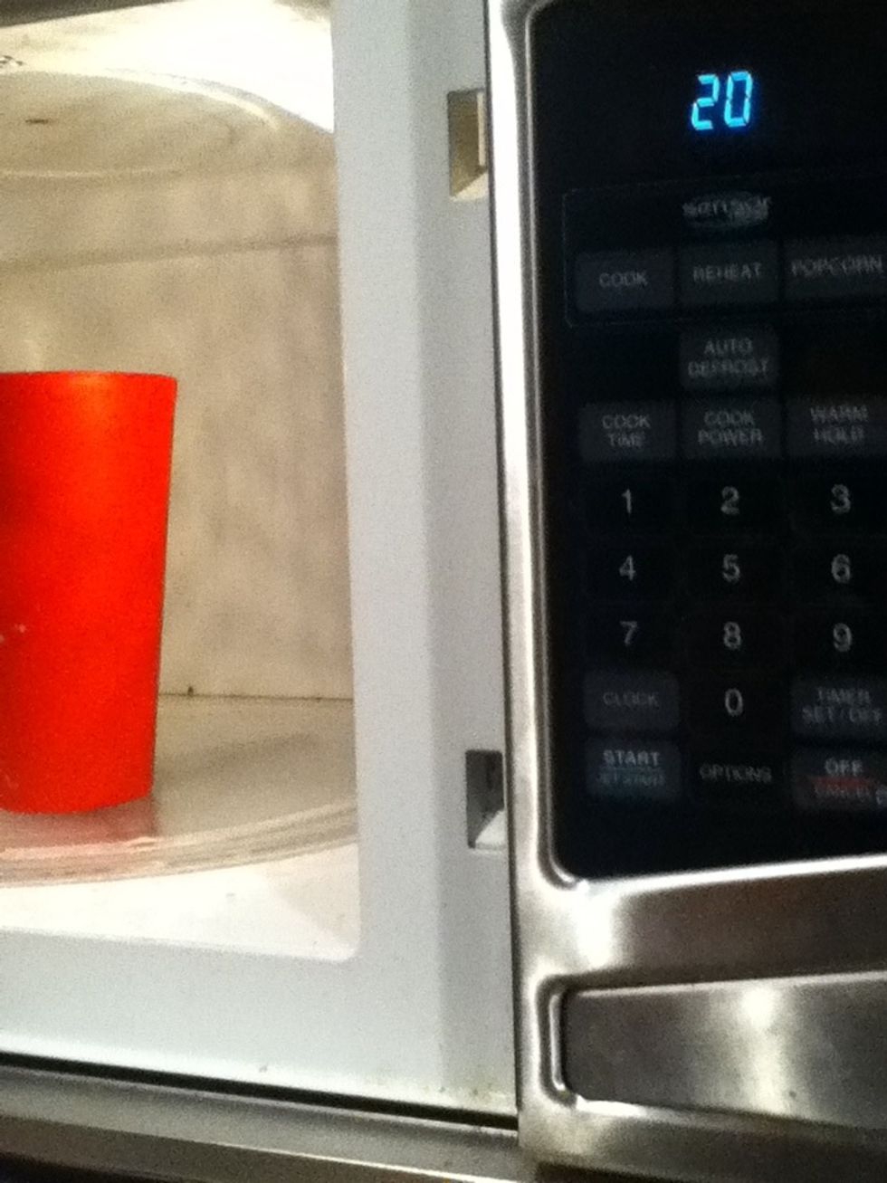 Put ice cream filled cup in microwave for 20 seconds.