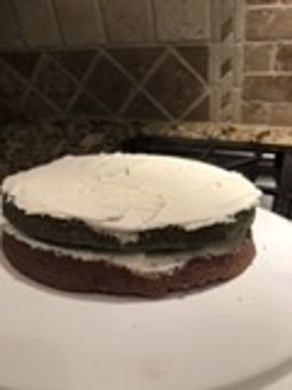Put icing in top of the blue layer until fully covered.