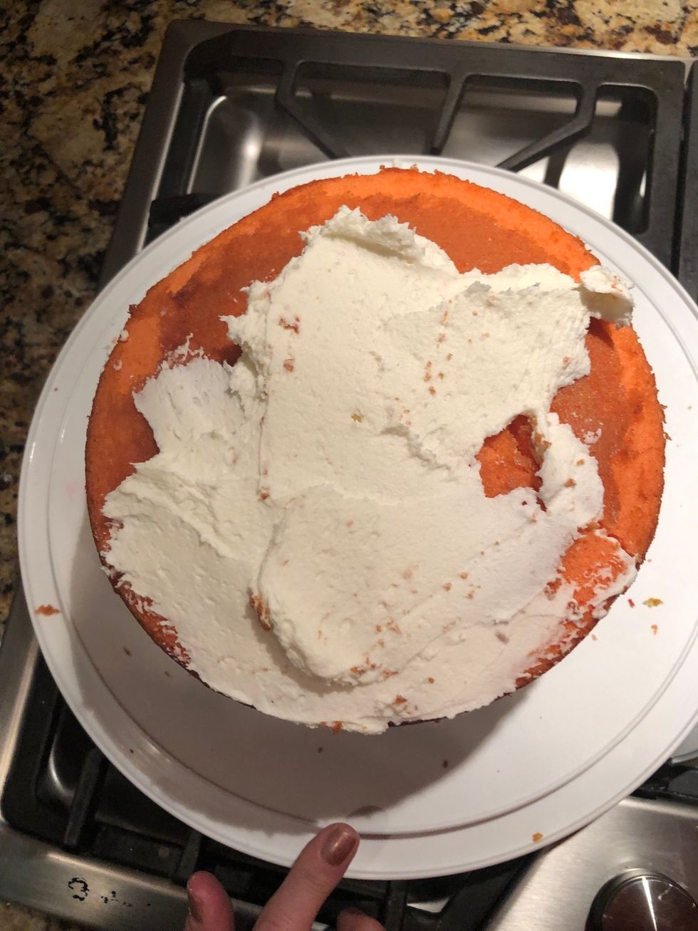Put icing on top of the orange layer until fully covered.