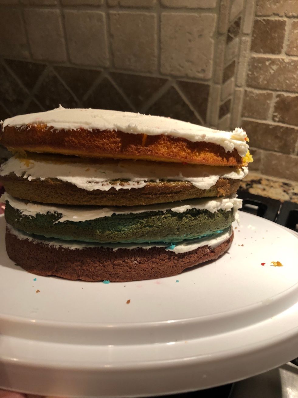 Put icing on top of the yellow layer until fully covered.