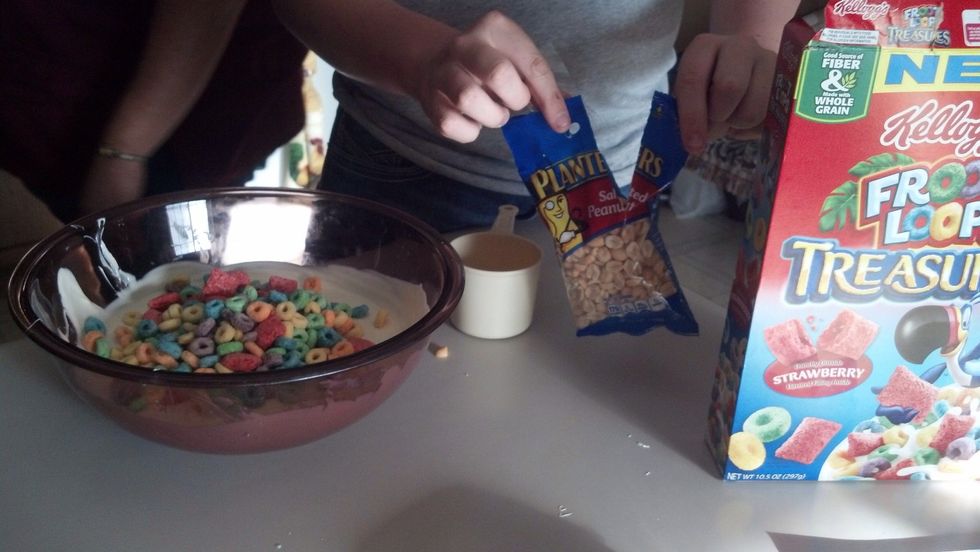 Put in 2 cups of penuts and fruit loops into the melted almond bark.