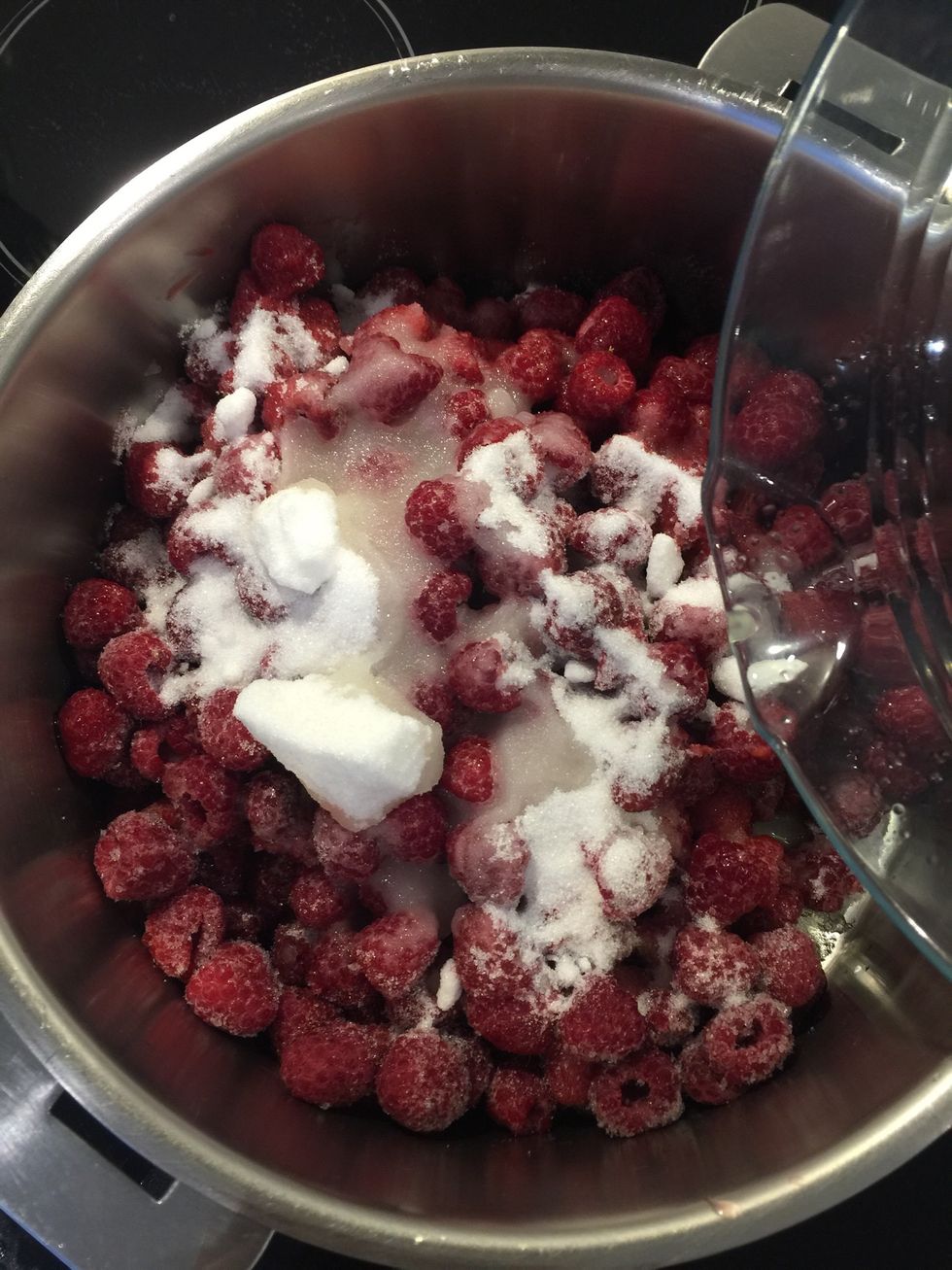 Put in a cooking pot with the lemon juice and sugar. Add the vanilla. Cook on medium low until the sugar melts and makes a syrup with the raspberry juice. Do not squash the raspberries