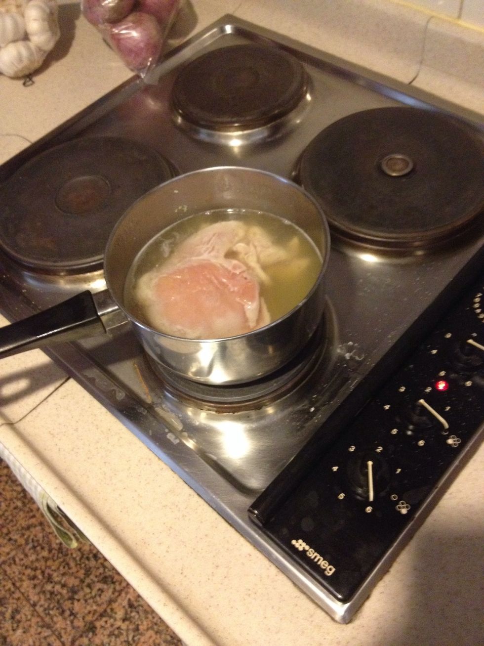 Put in a pot of boiling water or broth. Wait until it reach rolling boil, then reduce to simmer for 10 minutes. This way the breast remains tender and cooked perfectly.