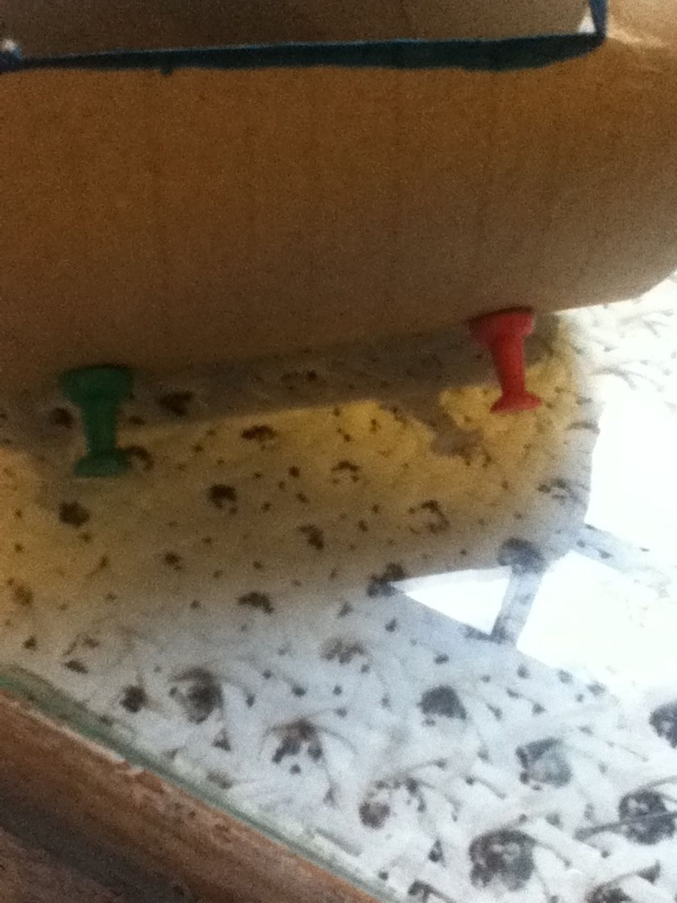 Put in the push pins at the back to stand it up. Adjust them if needed.