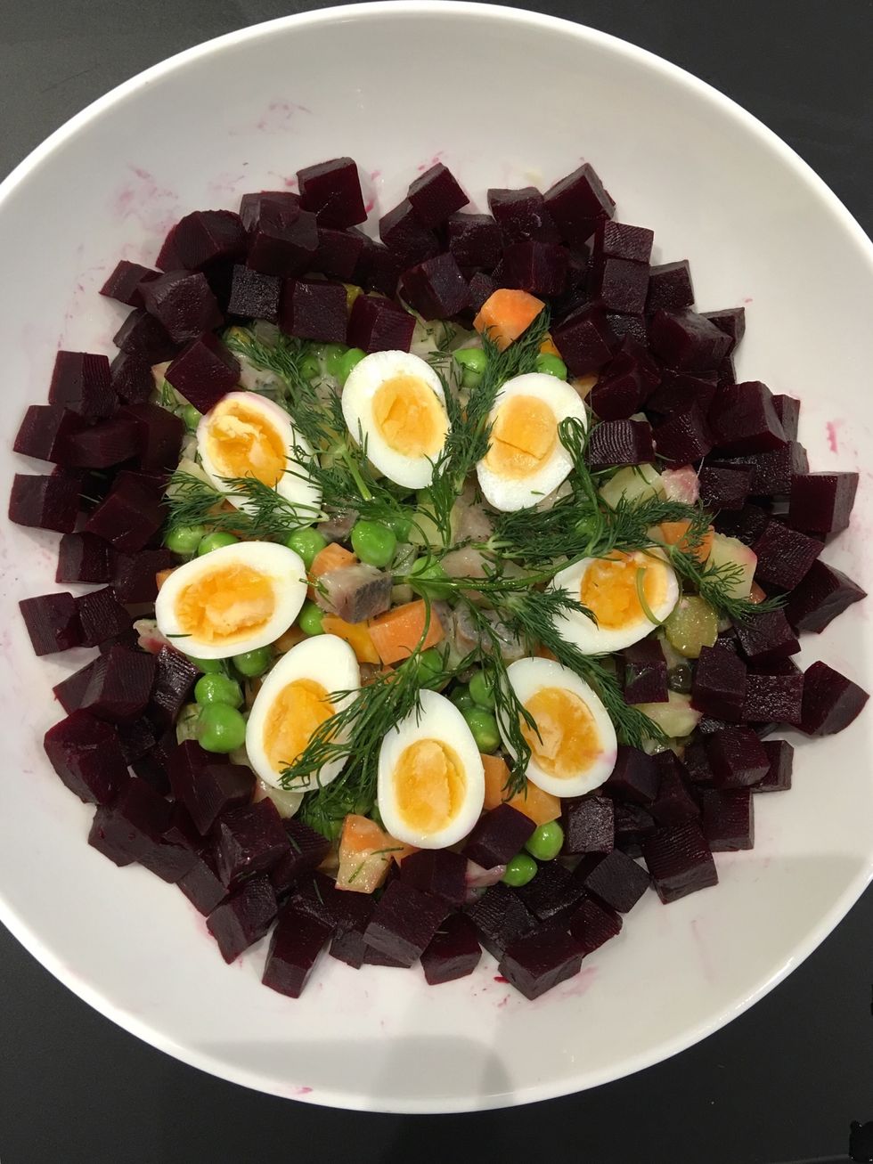 Put in the serving dish. Cut the eggs in half. Put on the top. Put the beet roots . Decorate with dill. Serve with more sour cream on the side