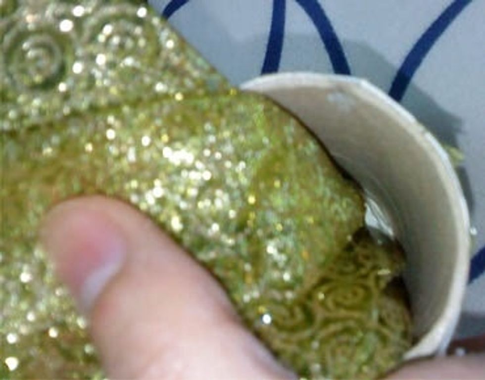 Put inside the roller a piece of fabric you may use the same color you used wraping the roller or any color you like