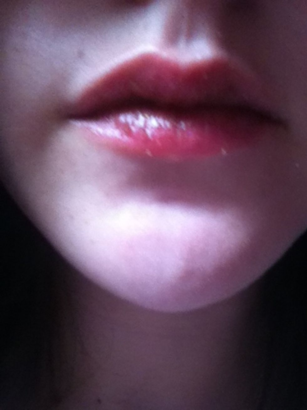 Put it all over your lips and lick it or wash it off. It is edible.