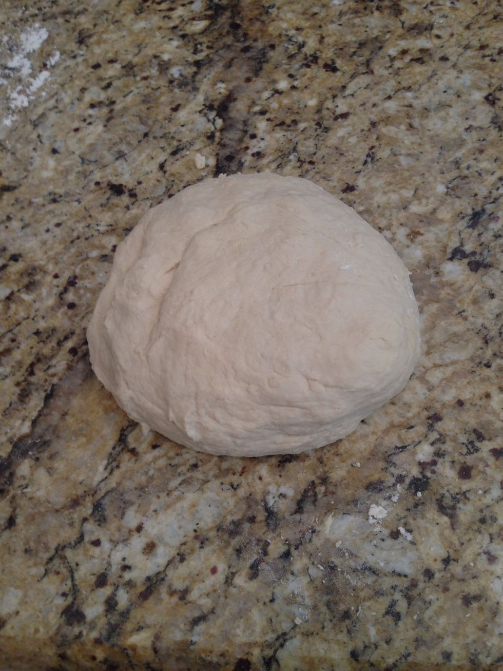 Put it in a bowl, cover it with a damp cloth and let it rise somewhere warm for about an hour until it doubles in size