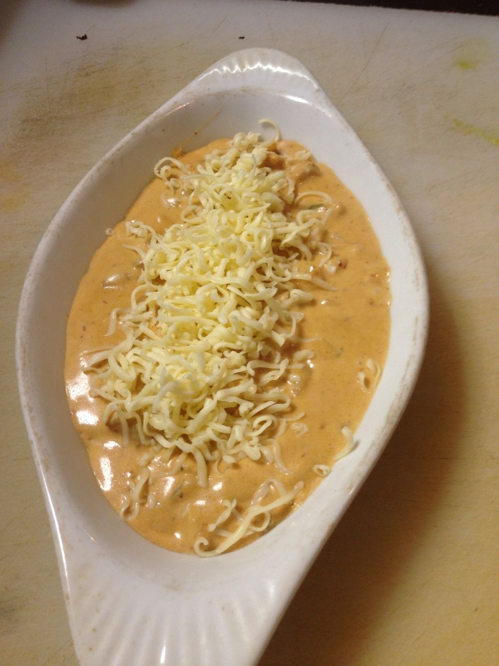 Put it in a oven proof plate and put more cheese on top, pop it in the oven until the cheese has a golden color.