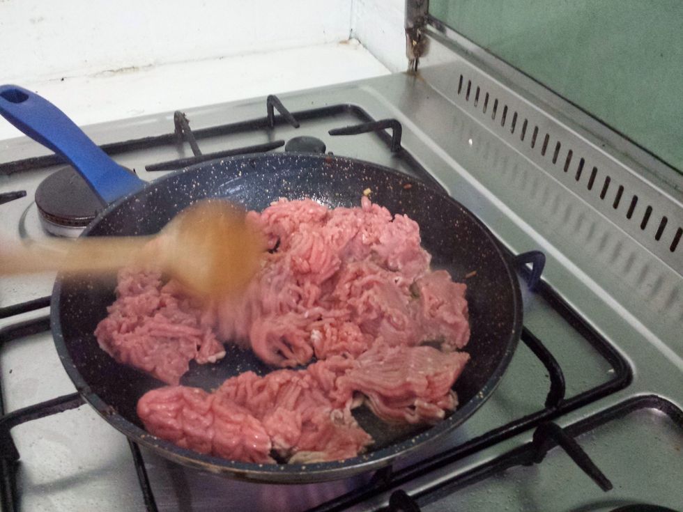 Put it in and break it up with your wooden spoon.