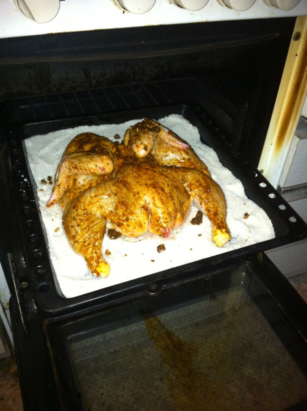 Put it in preheated oven to 200 C or 400 F for about 40 minutes (depends on the size of the chicken)