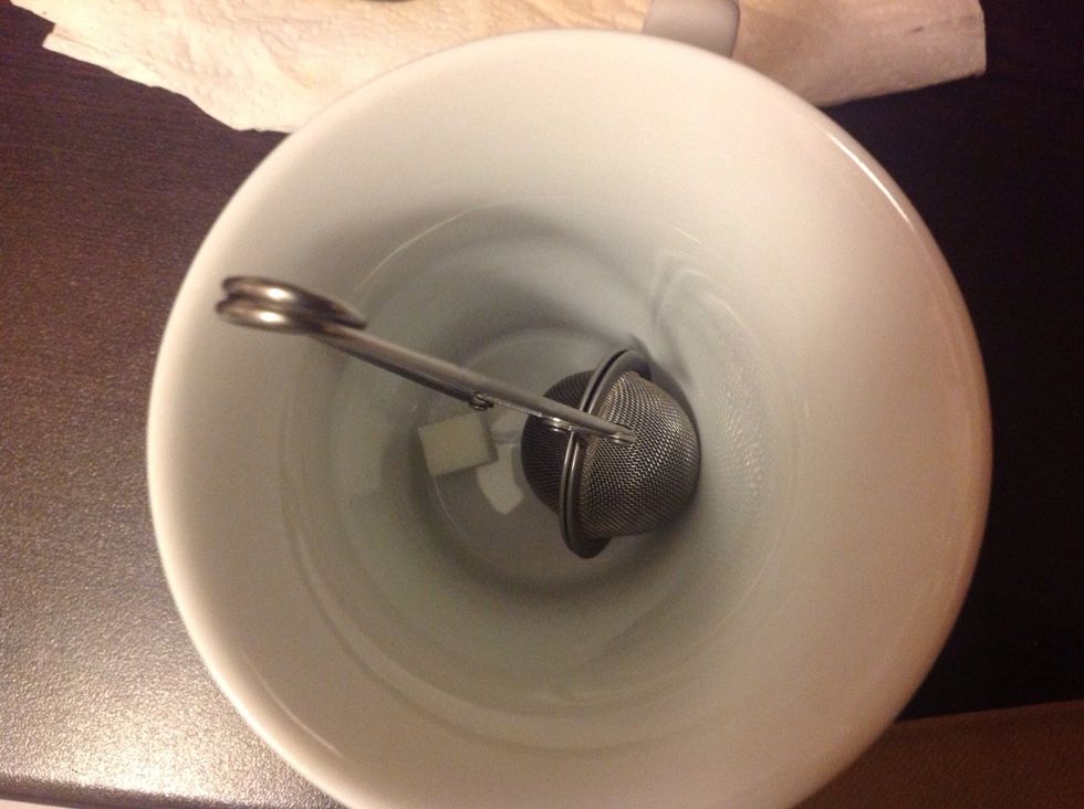 Put it in the cup along with a cube of sugar. Add boiled water on top.