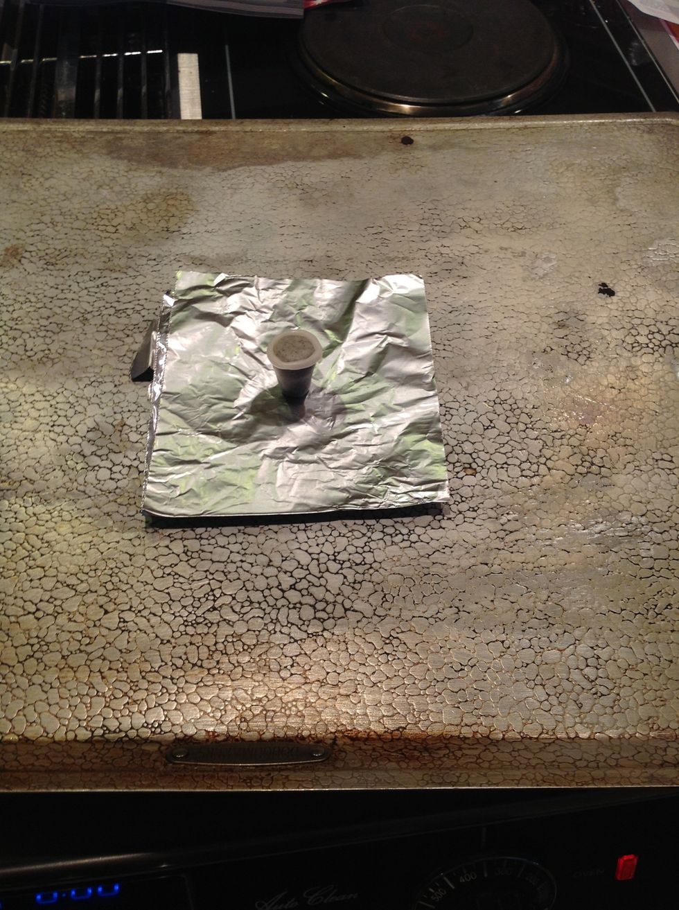 Put it in the oven with tinfoil under it