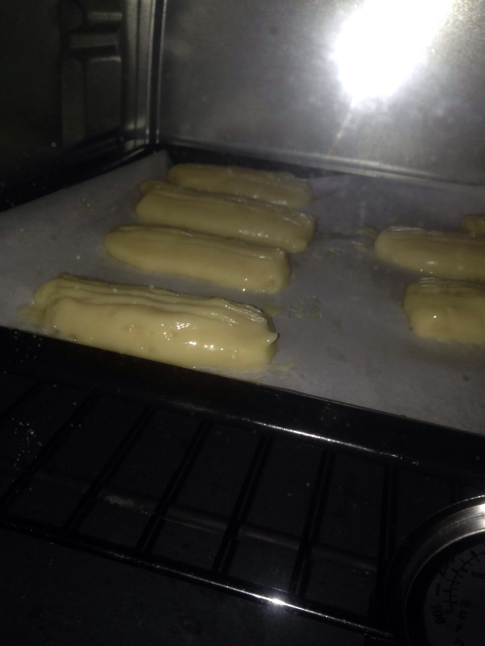 Put it in the pre-heated oven and bake for about 15 minutes on 200'C (thats 400'F) then lower the oven temperature to 180'C (350'F) and continue to bake them for about 25minutes