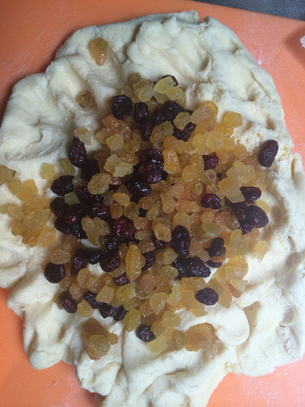 Put it on a floured surface spread by hand add the dried fruits and 1 Tsp of salt fold in the dough to incorporate them. The light in this picture make the dough looks white\ud83d\ude00