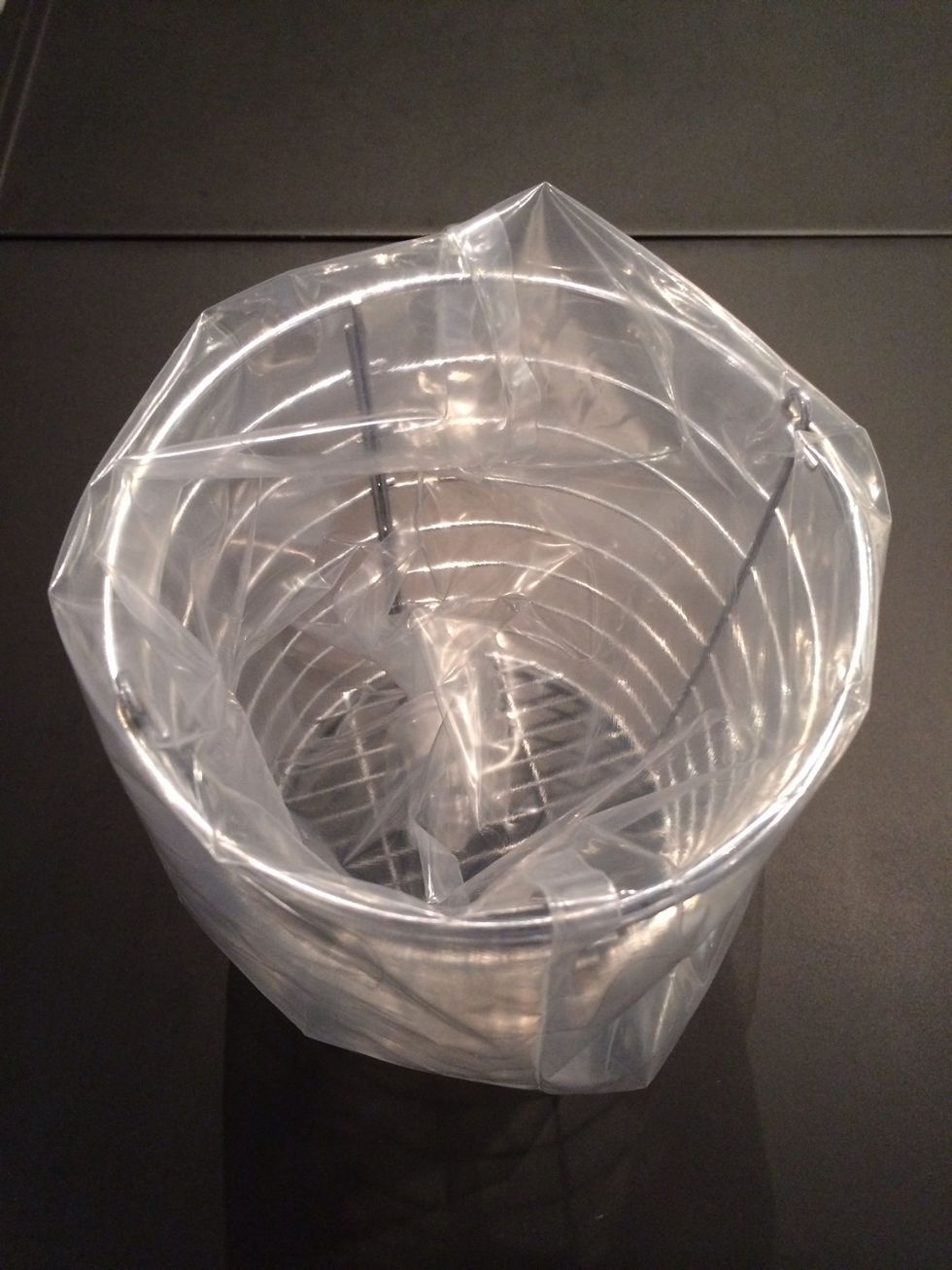 Put it on a support. This way it is easier to fill the piping bag