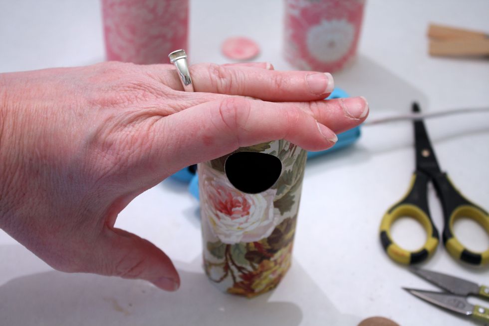 put it on the base, then place on table and press down- if you want you can use a pencil on the eraser side to press down into the basket