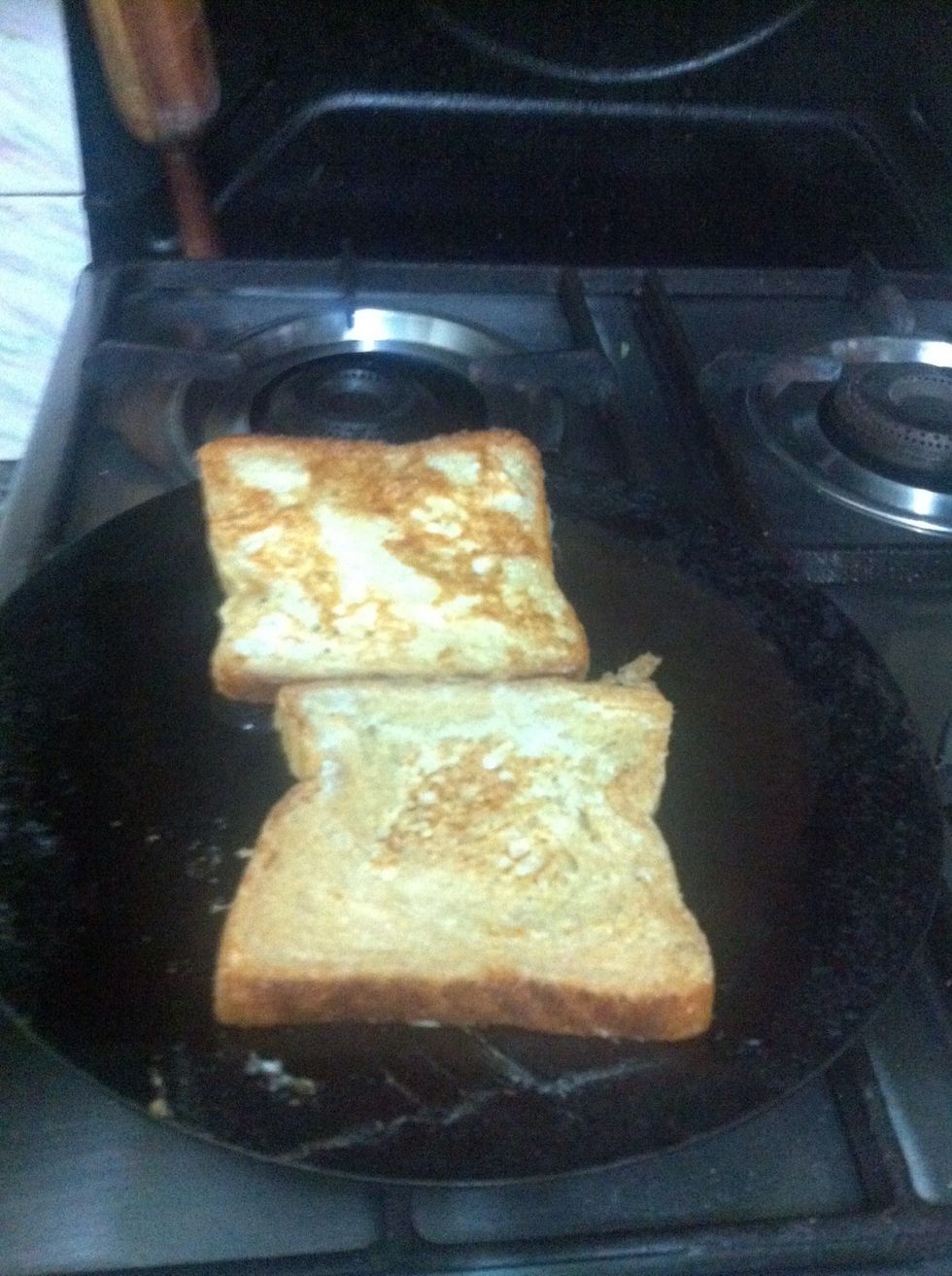 Put it on the pan having oil on the stove. Oil should be spread all over the pan. Flip the bread.