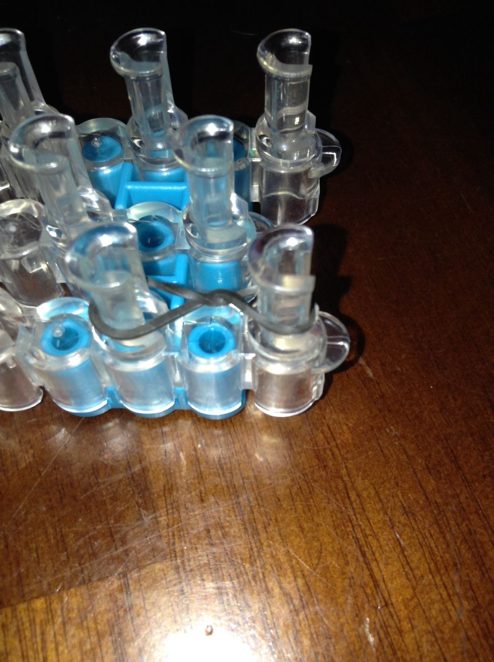 Put it onto the 2 pegs