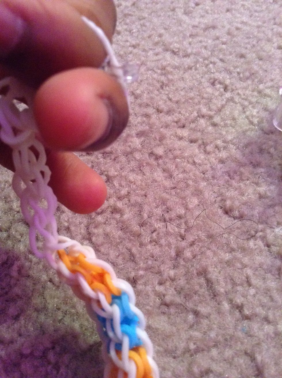 Put it over your last extension rubber band and connect to he other side of the bracelet