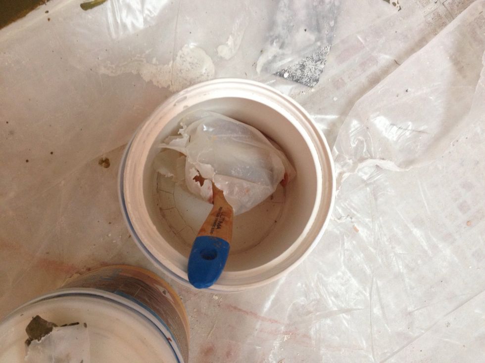 Put it somewhere safe & out of the way where you won't step on it & get paint all over the place. An empty dried out gallon paint bucket works nicely. This will keep the paint fresh for a day or so.