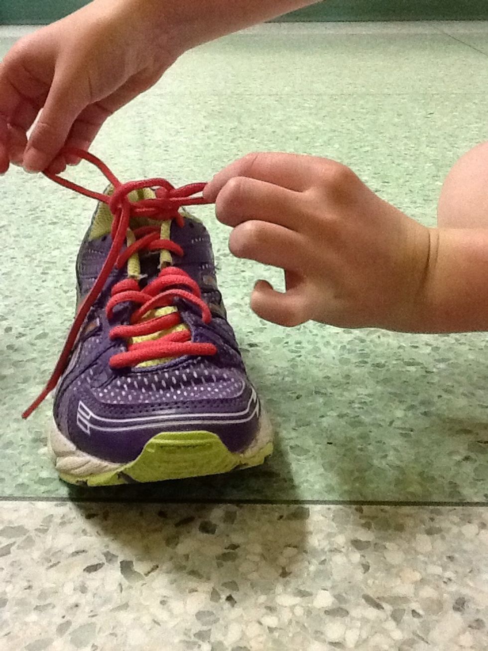 Put it through the hole to make another "bunny ear." Then pull tight.