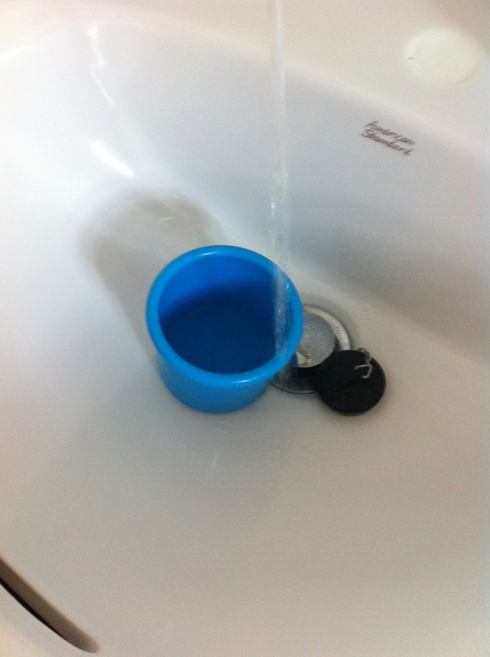 Put just a little water in your cup/bowl. We are now going to make a water and glue mixture, but we don't want it to be TOO watery!