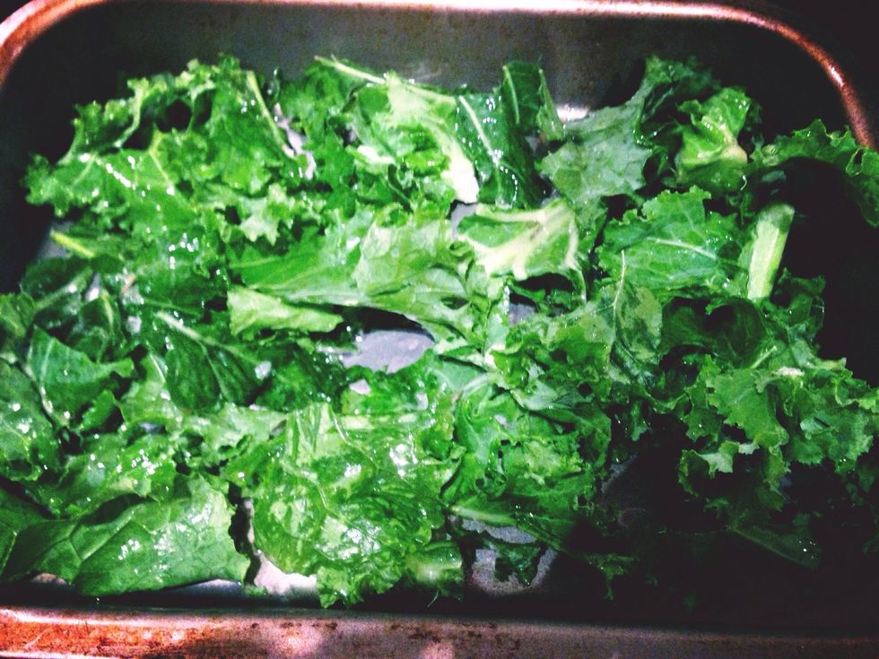 Put kale in the baking tray. Add oil and salt. Mix together until kale is covered by oil and salt