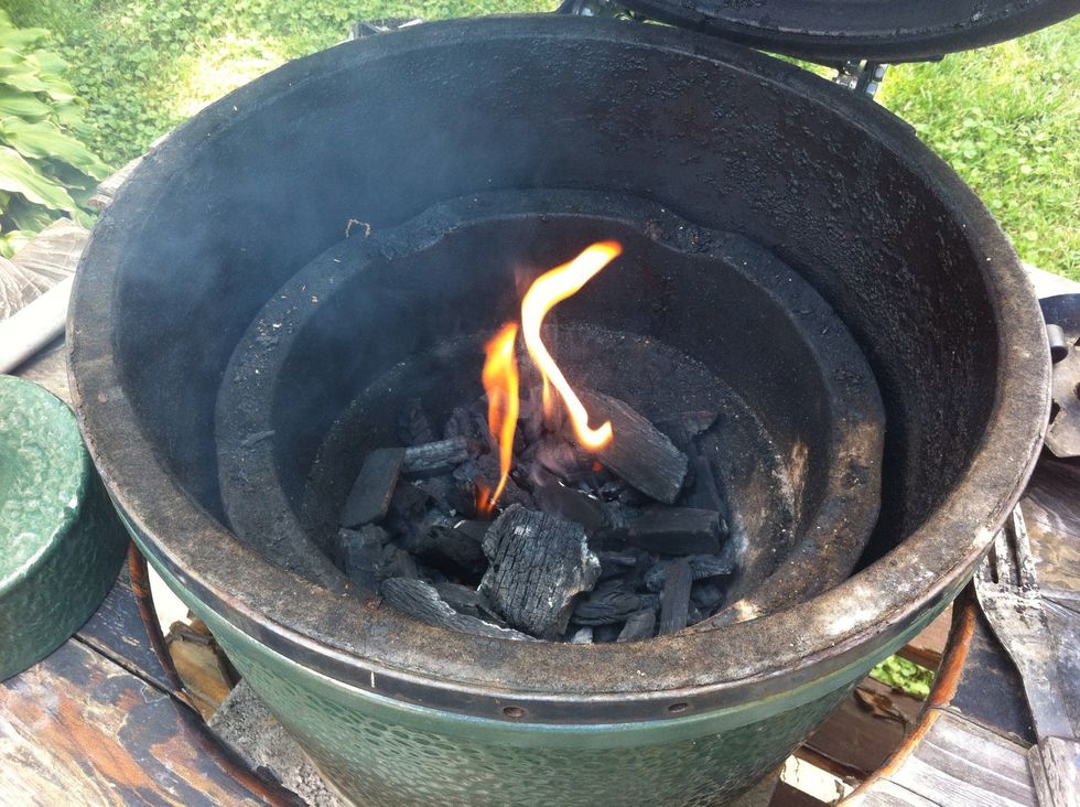 Put lump charcoal into grill and start fire.