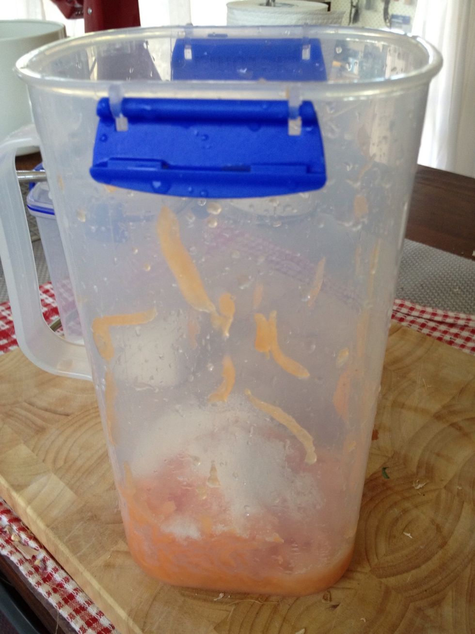 put melon shreds in pitcher, add sugar