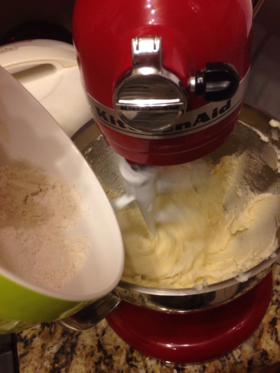 Put mixer on low speed and slowly add flour mix in installments.