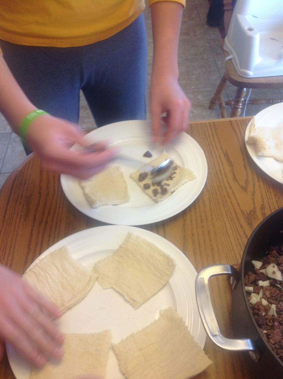 Put mixture in dough (about a spoonful)