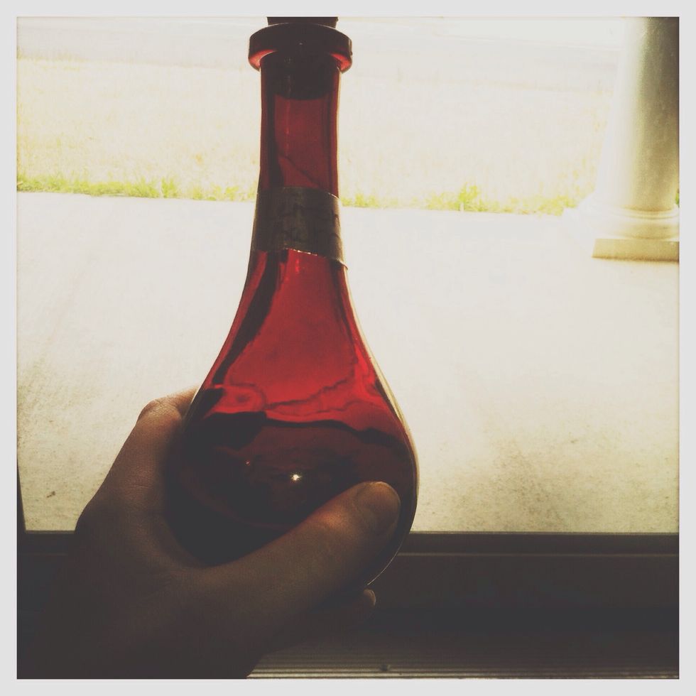 Put more of the same herb into a clean, dry glass bottle (sandalwood in this case). Then, pour all of the remaining liquid from the tincture into the bottle to cover the herbs.