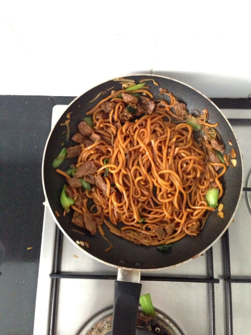 Put oil and garlic on the pan. Fried noodle on the pan followed by the meat and veggies.  Add some sweet sauce, oyster sauce, salt, pepper and msg