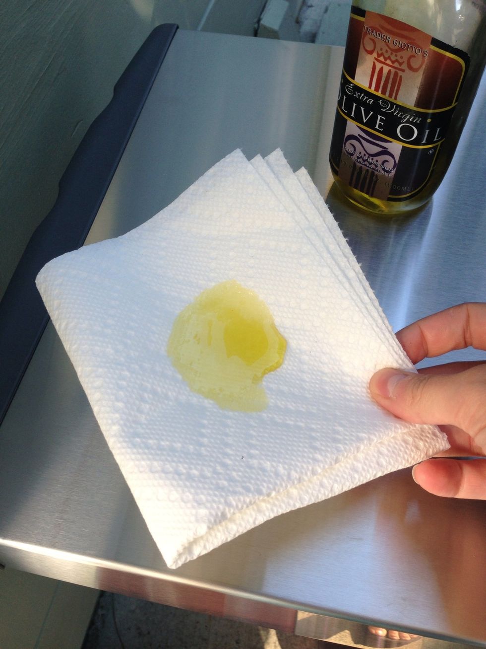 Put oil on a cloth. I used a paper cloth, but a real one is better since it won't leave particles behind.