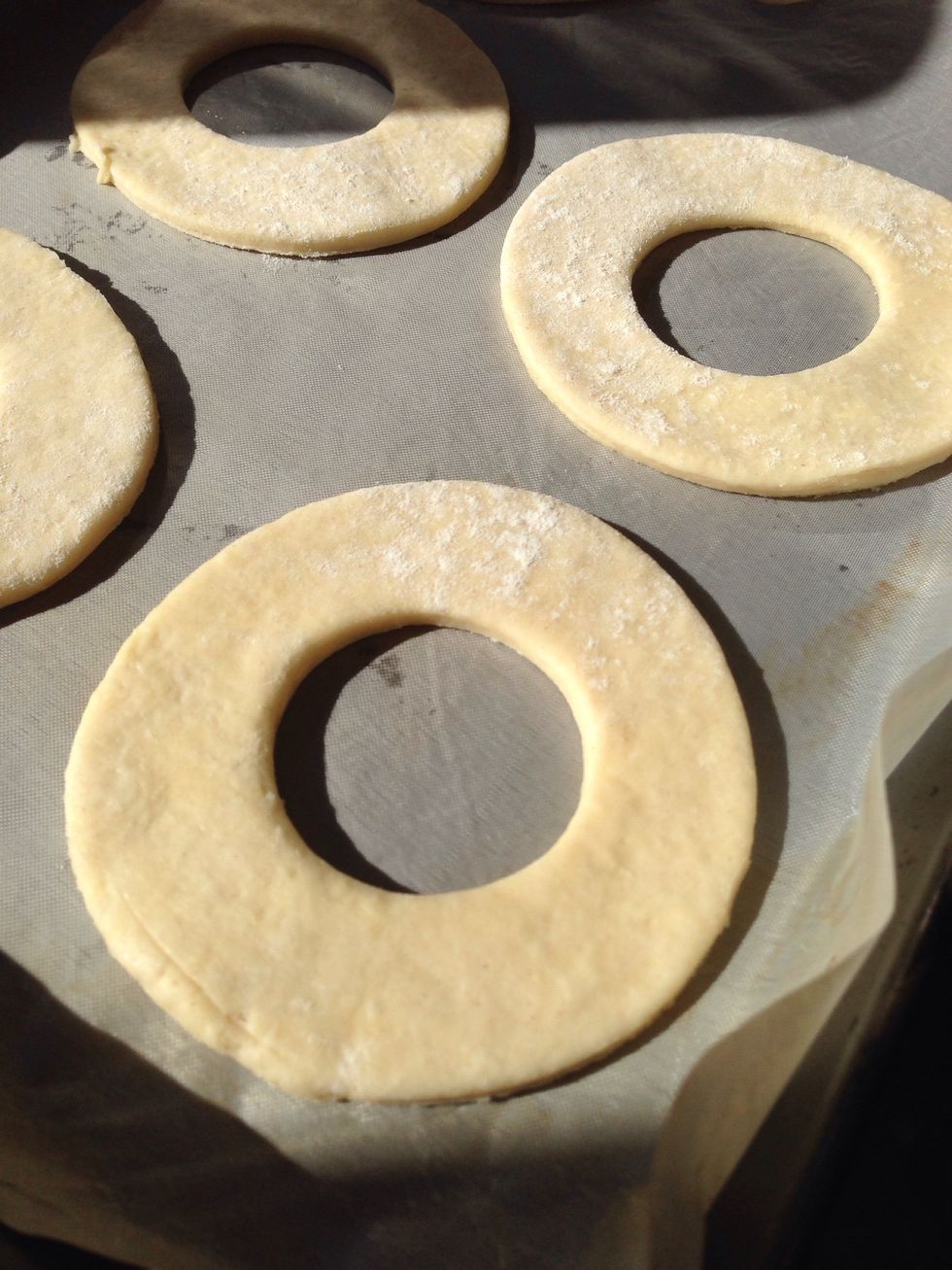 Put on a baking tray and cover loosely with cling film. Allow them to rise for about an hour